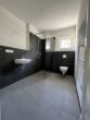Moderne 1,5-Zimmer-Neubauwohnung mit Terrasse und Garten in Nauen - Bad