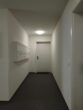 Moderne 1-Zimmer-Neubauwohnung mit Terrasse und Garten in Nauen - Hausflur