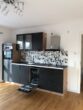 Gepflegte 2-Zimmer-Neubau-Wohnung mit Balkon zu vermieten - Wohnzimmer